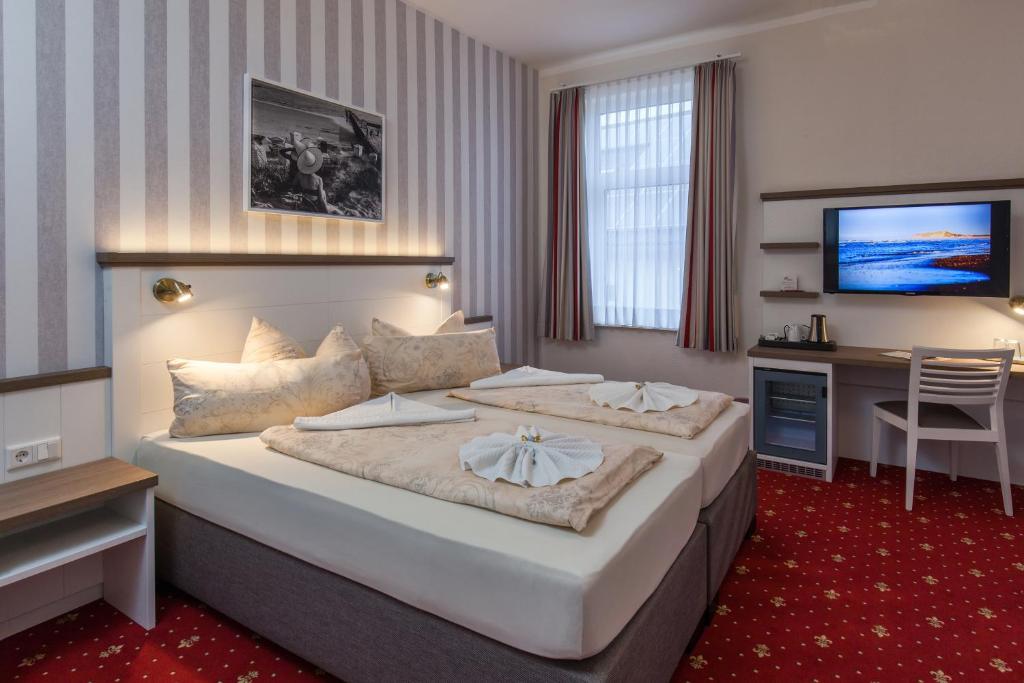 Postel nebo postele na pokoji v ubytování Hotel Weisse Düne