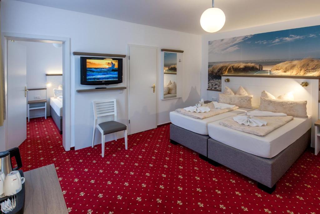 Postel nebo postele na pokoji v ubytování Hotel Weisse Düne