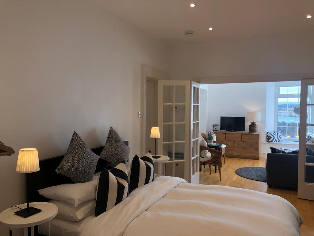 a bedroom with a bed and a living room at The Harbour Studio in Portrush