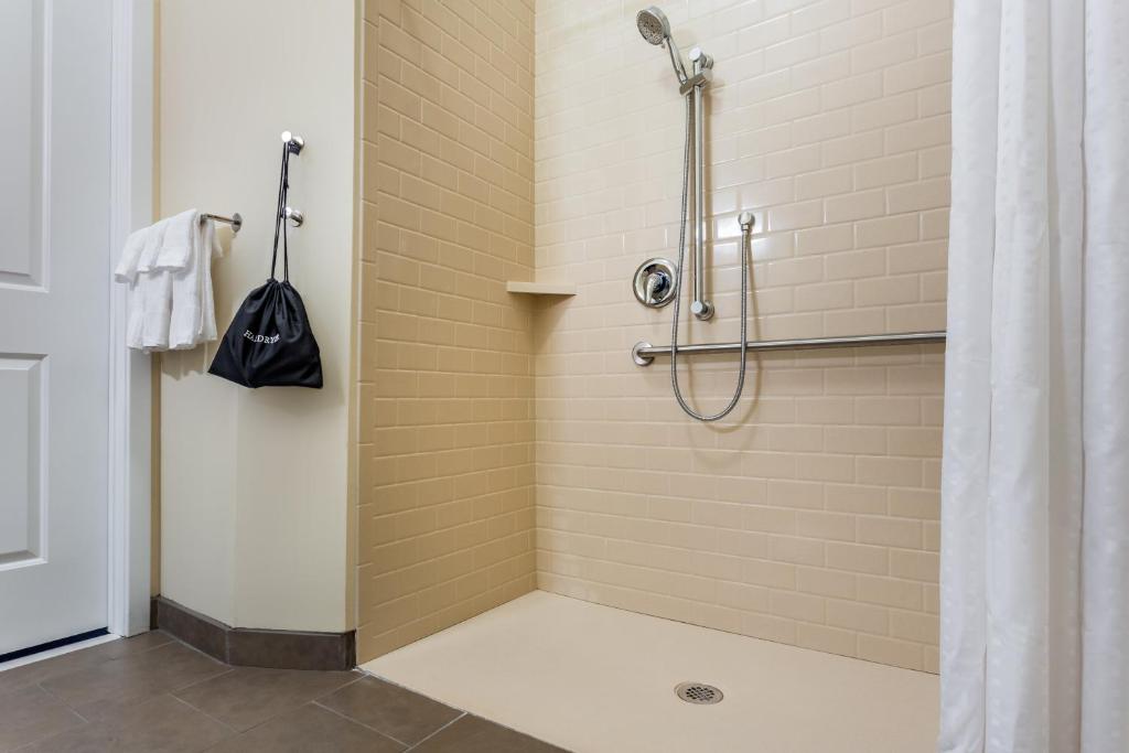 a bathroom with a shower with a shower curtain at Candlewood Suites Bethlehem South by IHG in Bethlehem