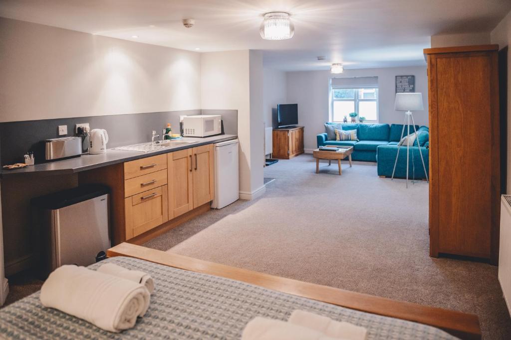 a room with a kitchen and a living room at Home Farm & Lodge in Bawtry