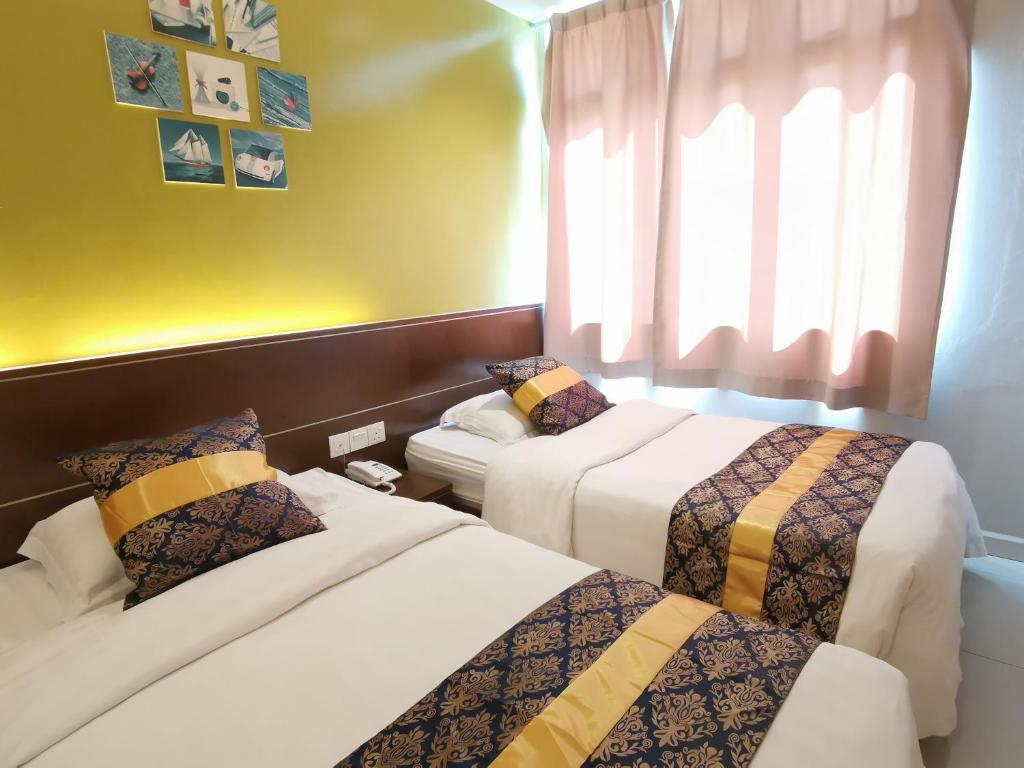 Postel nebo postele na pokoji v ubytování Star Bay Hotel