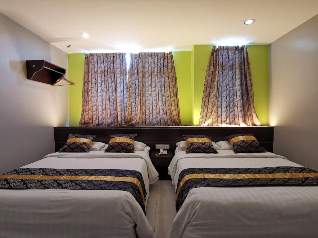 Postel nebo postele na pokoji v ubytování Star Bay Hotel