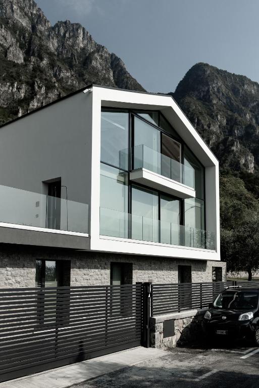 a house with a car parked in front of it at Italianway - Villa Paloma in Marone