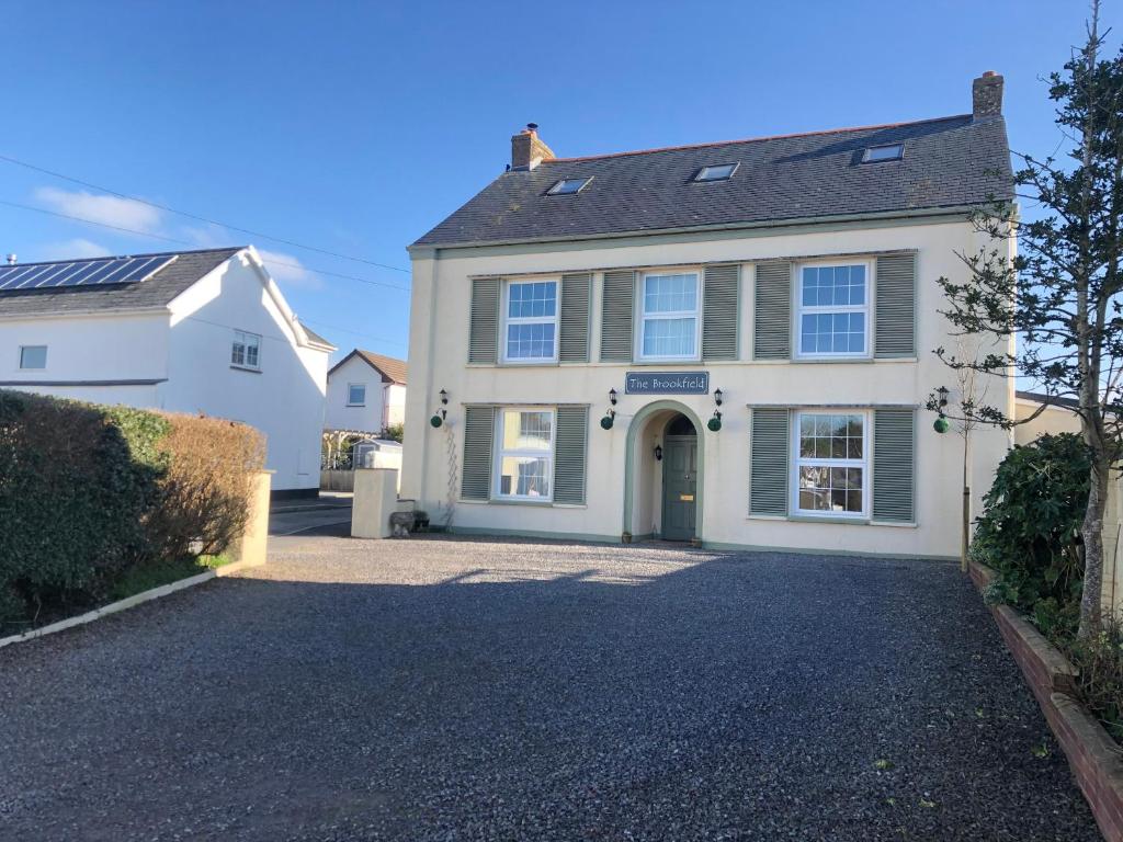 a large white house with a driveway at The Brookfield in Braunton