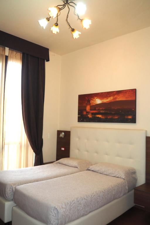 Łóżko lub łóżka w pokoju w obiekcie Hotel Ester
