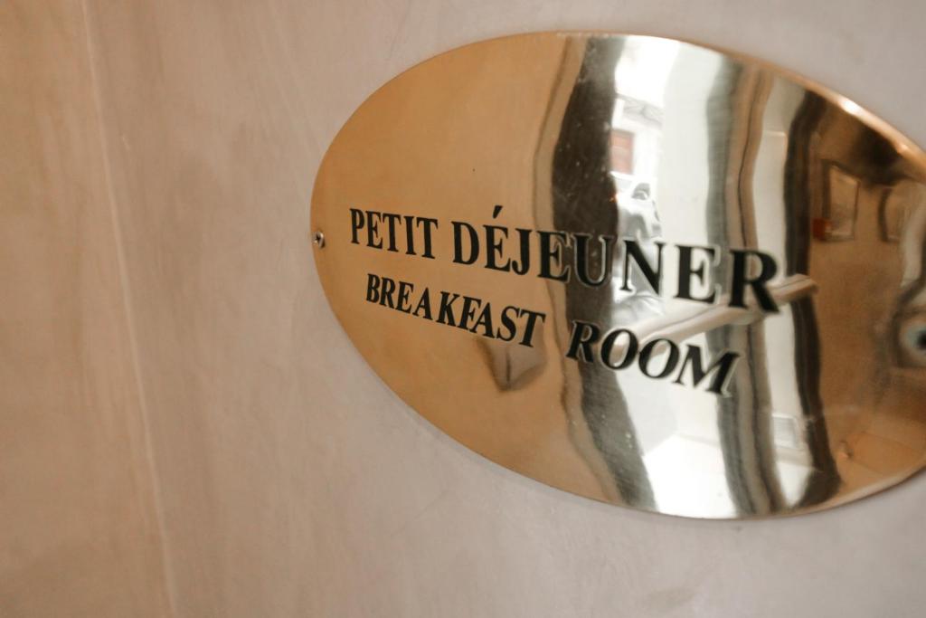 a mirror on a door with the words patient deterioration breakfast room at Little Hôtel in Paris