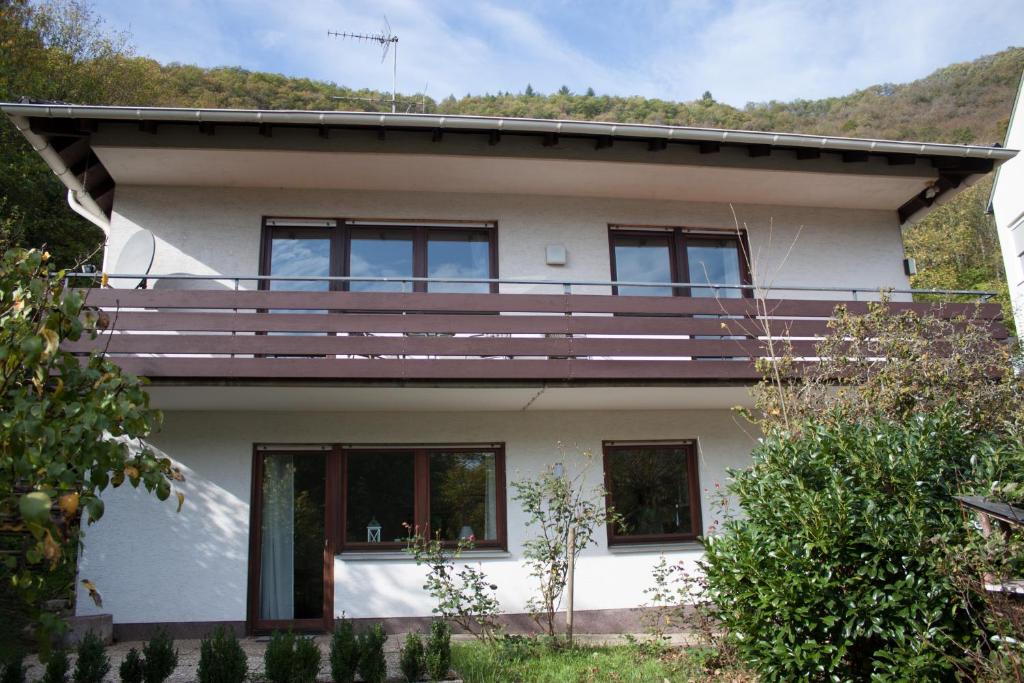 a house with a balcony on top of it at Haus zur Sonne in Bad Bertrich
