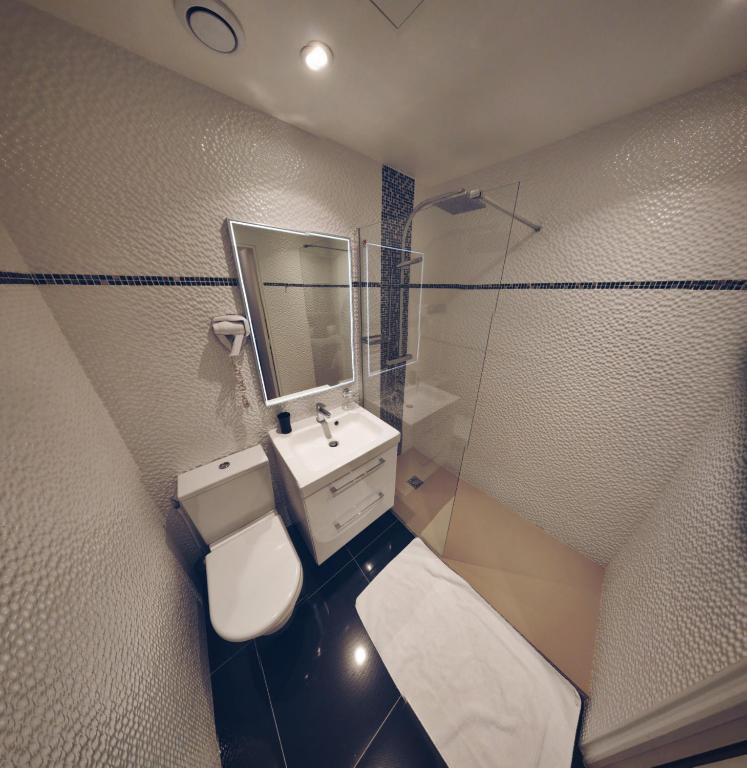 a bathroom with a sink and a mirror at Little Hôtel in Paris