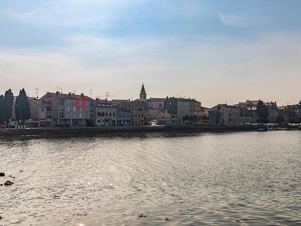 a large body of water with a city in the background at Bella Vista Premium Apartment in Poreč