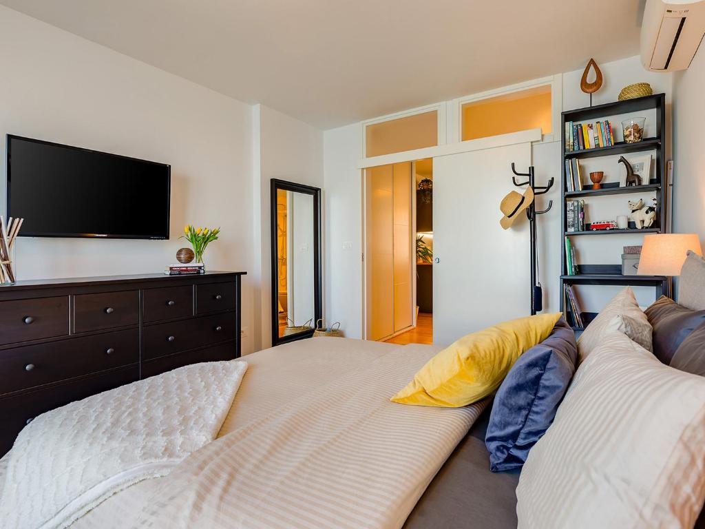 a living room with a couch and a flat screen tv at Bella Vista Premium Apartment in Poreč