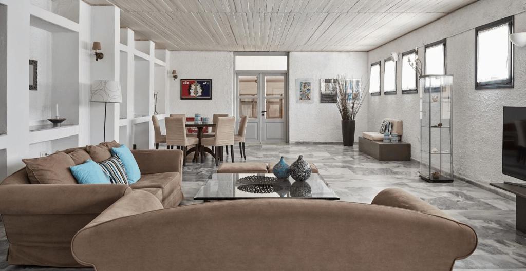 a living room with two couches and a table at Mare Vista Hotel - Epaminondas in Batsi