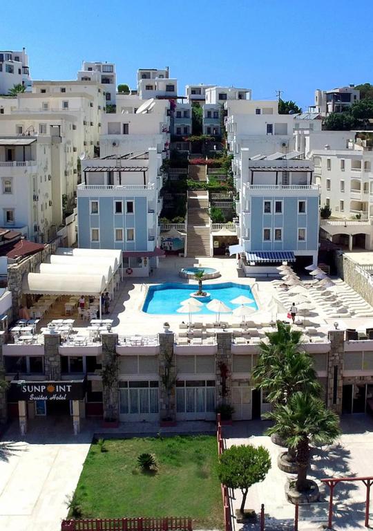 an aerial view of a building with a swimming pool at Sunpoint Hotel Bodrum in Bodrum City