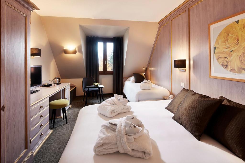 Postel nebo postele na pokoji v ubytování Hotel L'Europe
