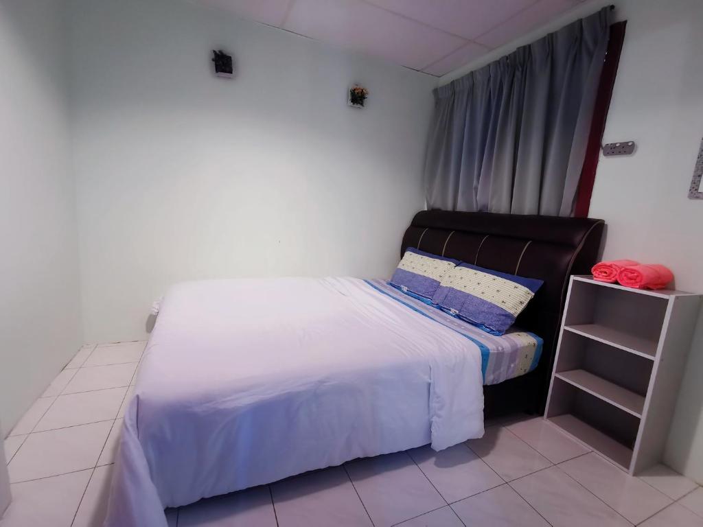 a small bedroom with a bed and a window at Sea & Wave #2 Coral Bay Apartment in Pangkor