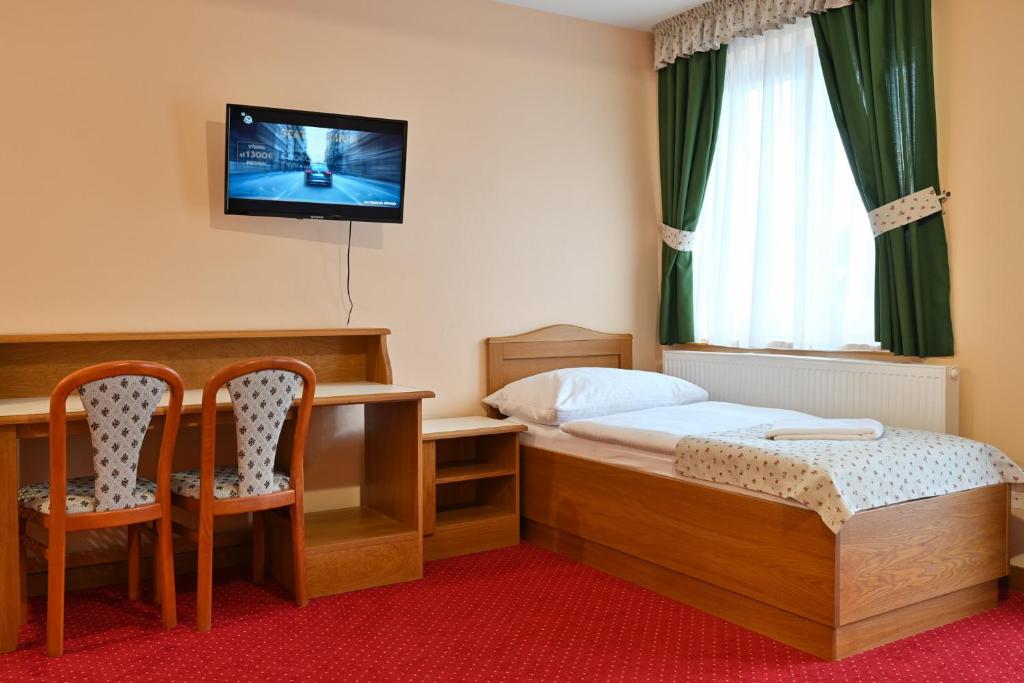 Postel nebo postele na pokoji v ubytování Hotel Julianin dvor