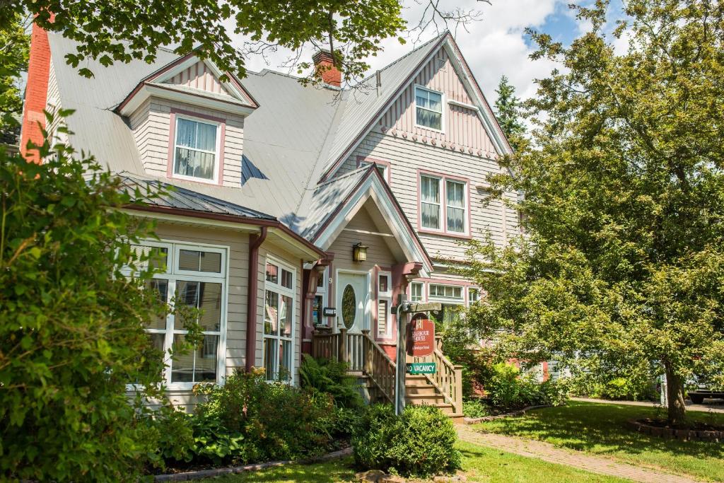 a large white house with a porch at The Harbour House in Charlottetown