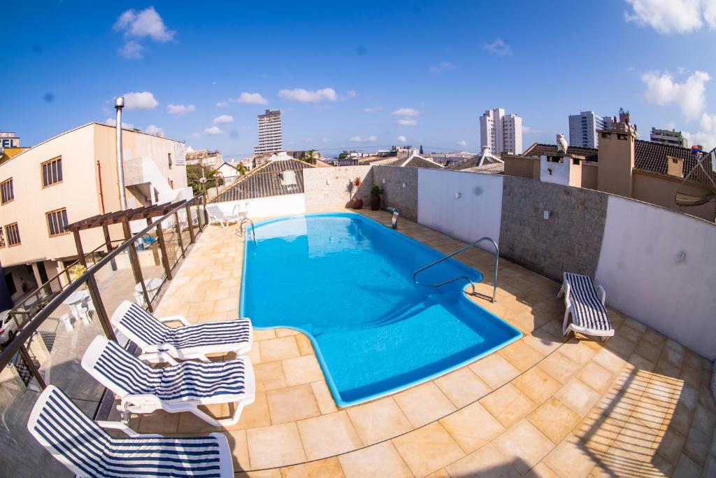 a swimming pool on the roof of a building at Hotel Mares do Sul in Tramandaí