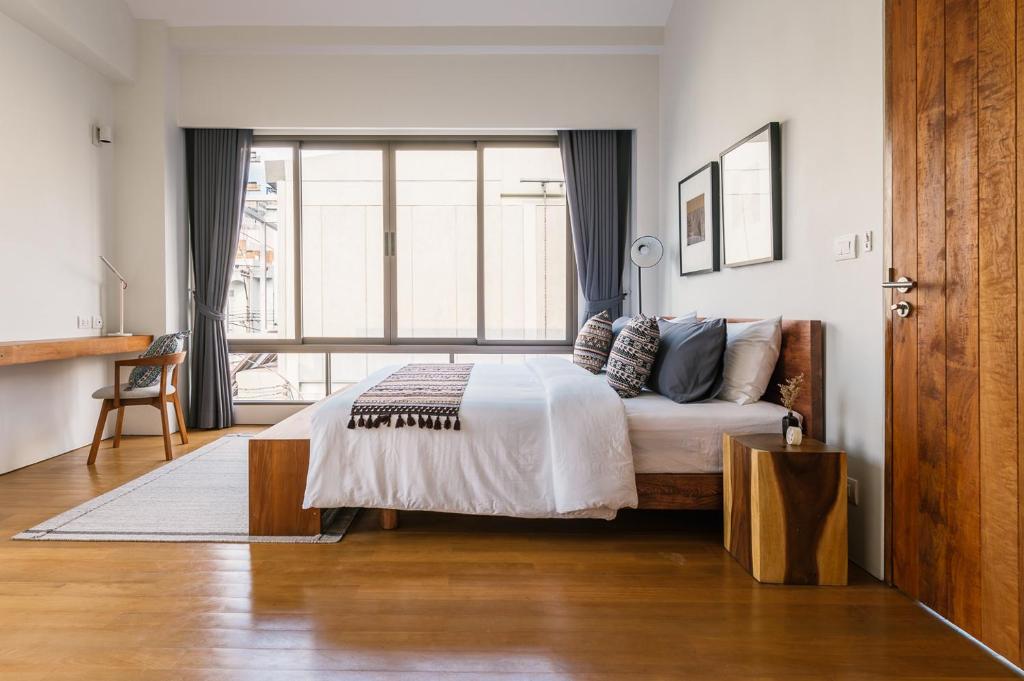 a bedroom with a bed and a large window at APT476 in Bangkok