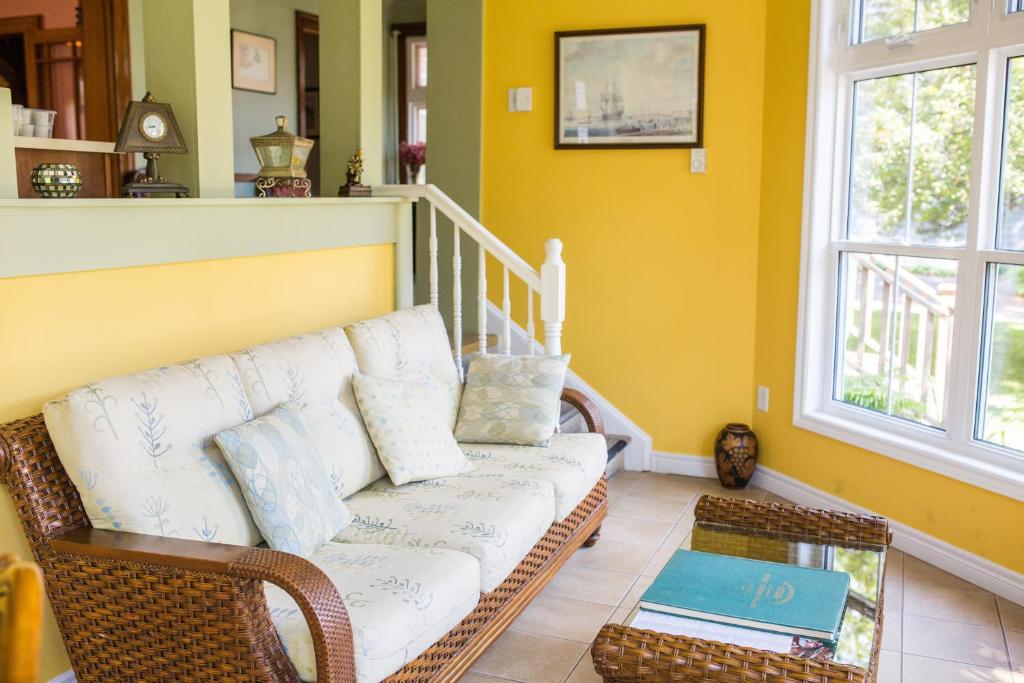 a living room with a couch and a table at The Harbour House in Charlottetown