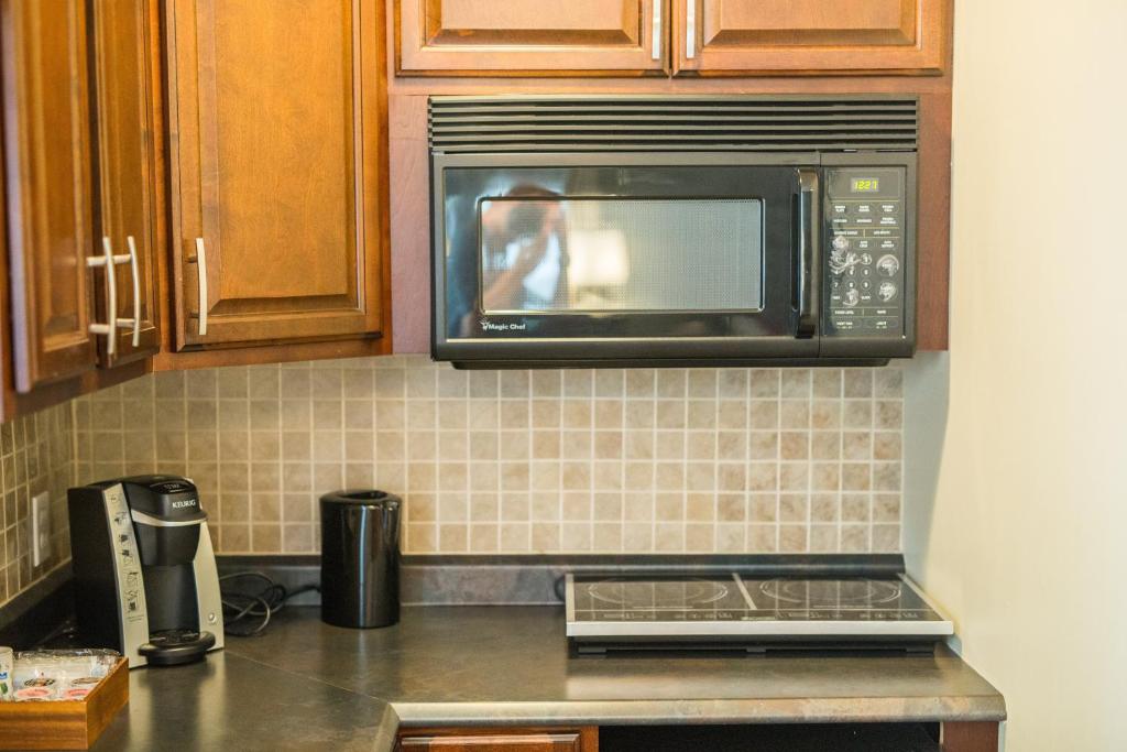 a kitchen with a microwave and a counter top at The Harbour House in Charlottetown