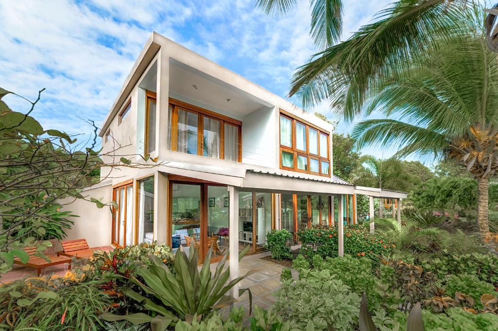 a large white house with windows and a courtyard at 473 Grenada Boutique Resort in Saint Georgeʼs