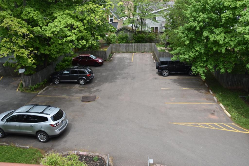 a parking lot with several cars parked in it at The Harbour House in Charlottetown