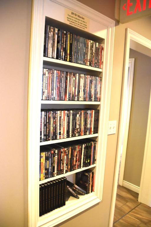 a book shelf filled with dvds at The Harbour House in Charlottetown