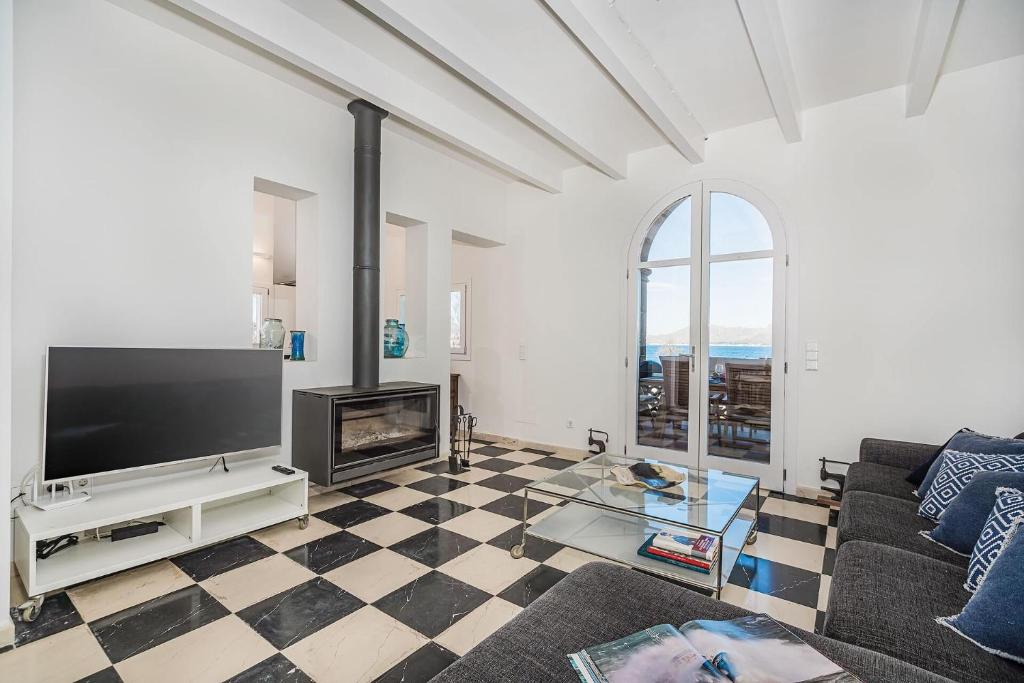 A television and/or entertainment centre at Beachfront Villa Es Clot by Sealand Villas