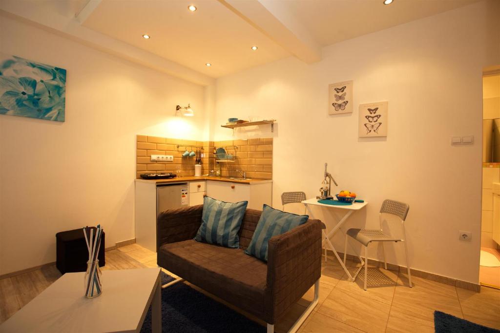 a living room with a chair and a table at Kahwa Central Apartments in Budapest
