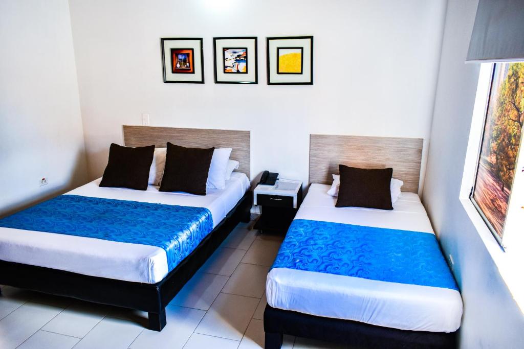Postel nebo postele na pokoji v ubytování Hotel Quinta Avenida