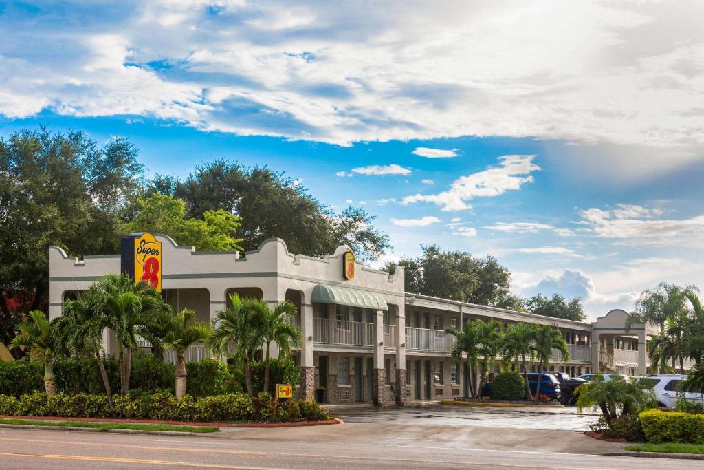 un restaurante mcdonalds con palmeras frente a un edificio en Super 8 by Wyndham Bradenton Sarasota Area en Bradenton