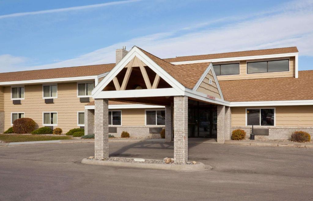 a large building with a building at AmericInn by Wyndham Crookston U of M Crookston in Crookston