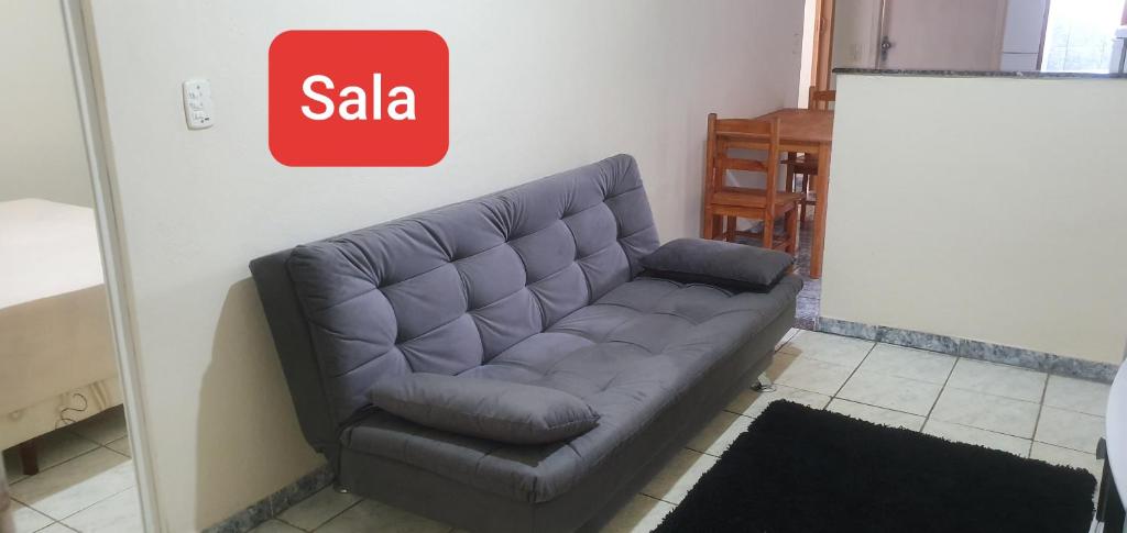 a couch in a living room with a sale sign at Pousada Estrela do Mar Angra dos Reis in Angra dos Reis