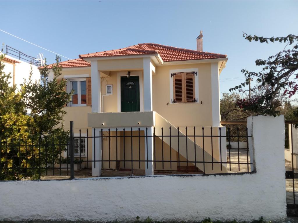 a house with a gate in front of it at Traditional Village House in Méson Yerakaríon