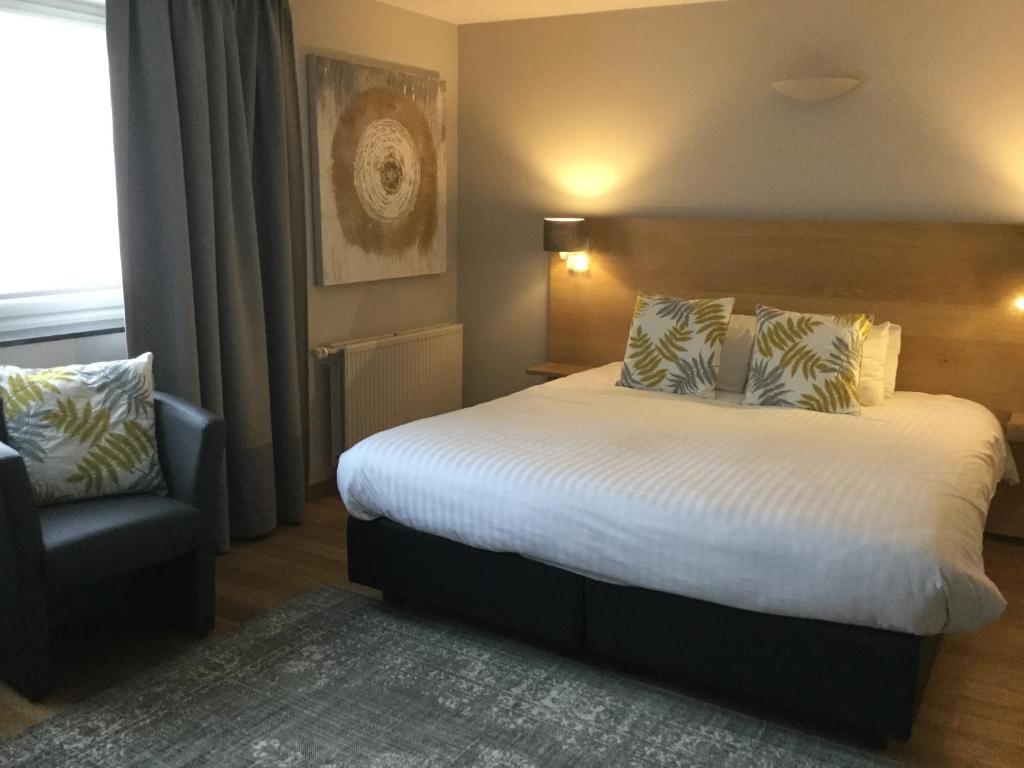 Postel nebo postele na pokoji v ubytování Hotel Côté Cour