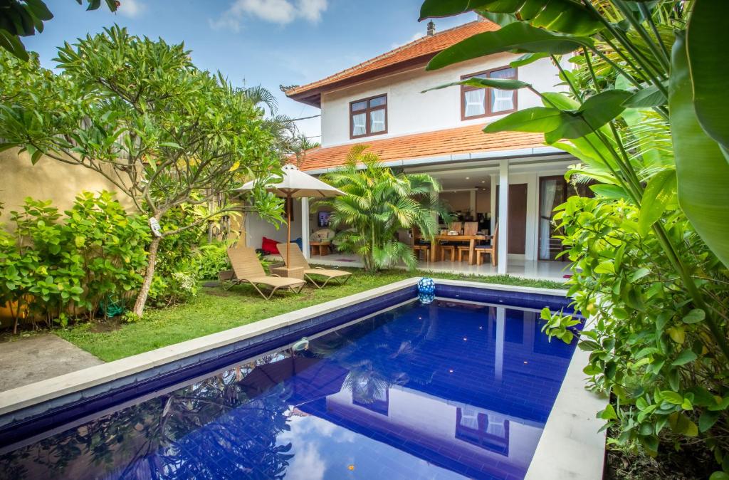 an image of a swimming pool in front of a house at Villa Rani 3 in Seminyak