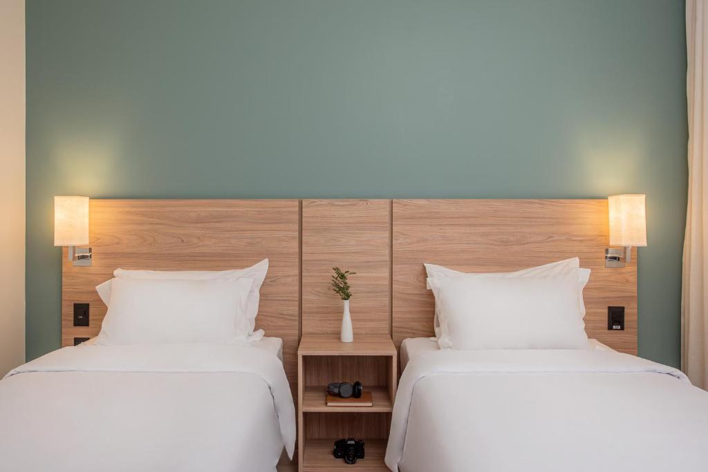 Cama ou camas em um quarto em Intercity Curitiba Batel