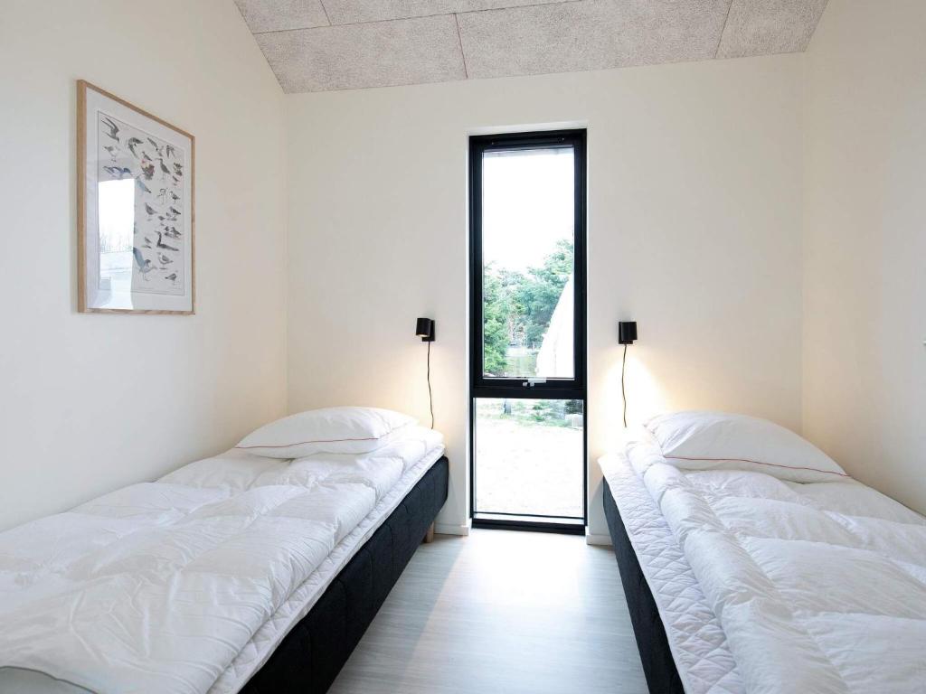 Postel nebo postele na pokoji v ubytování Holiday home Jerup XXXII
