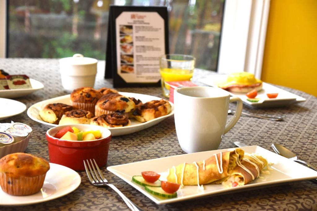 a table with plates of food and cups of coffee at The Harbour House in Charlottetown