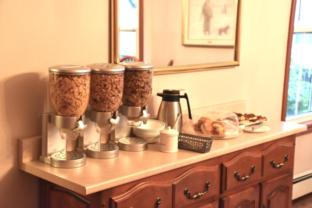 a counter with three feeding stations on a table with food at The Harbour House in Charlottetown