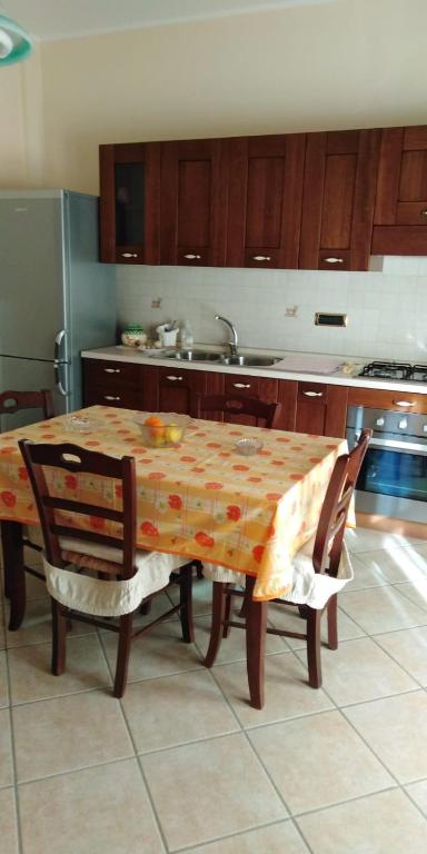 eine Küche mit einem Tisch mit 2 Stühlen und einem Waschbecken in der Unterkunft Nilu' e Sagio' in Baronissi