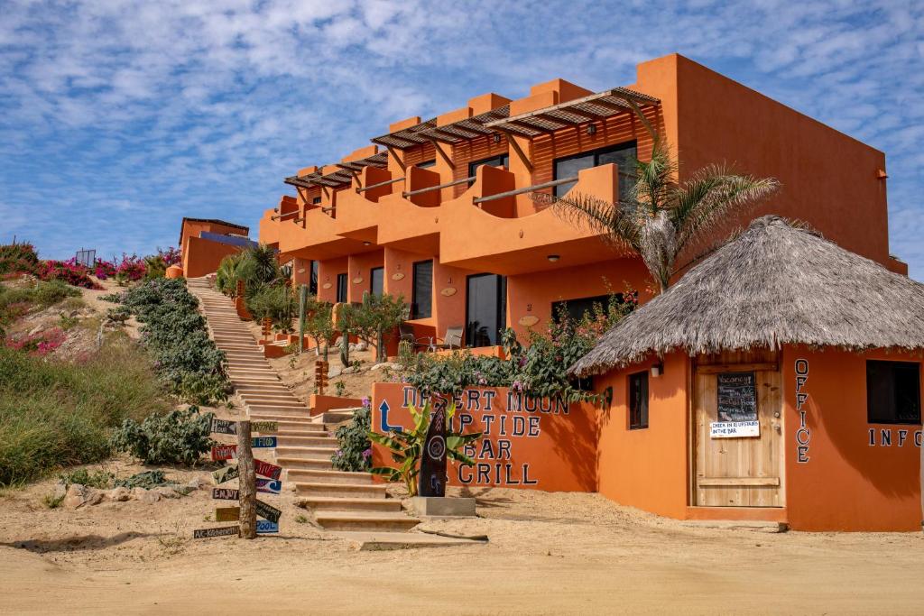 an orange building with stairs leading up to it at Cerritos Beach Hotel Desert Moon in El Pescadero