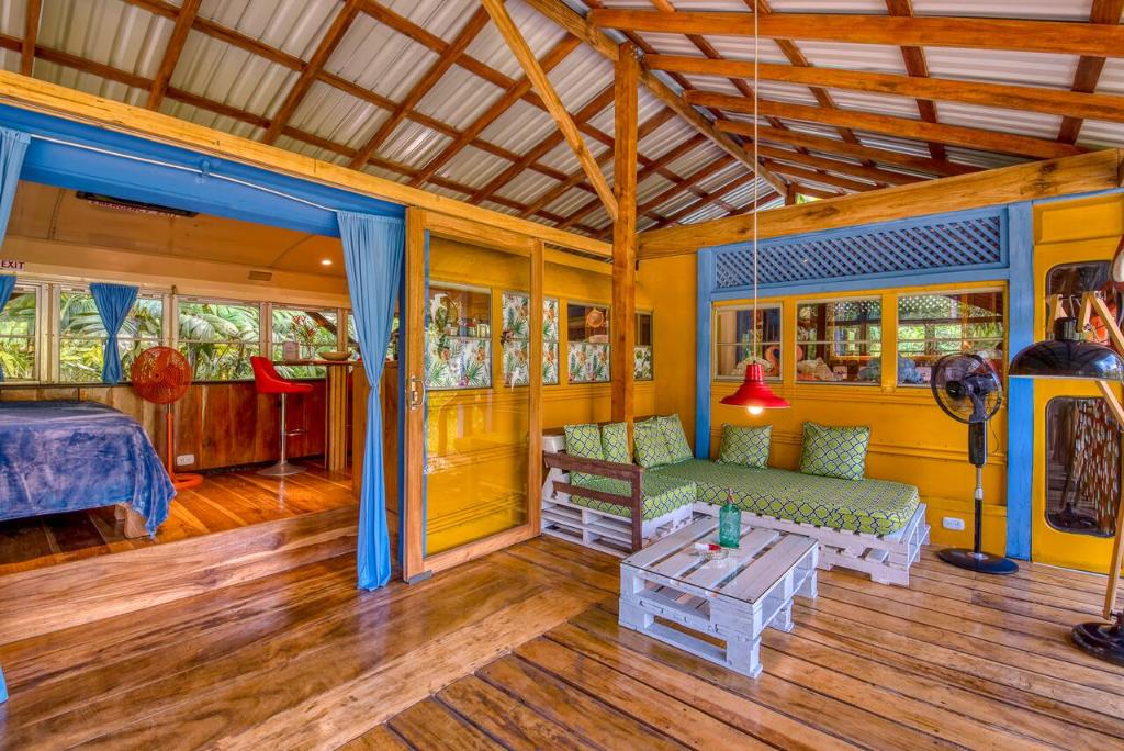 a living room with a couch and a table at Tree House Beachfront Lodge in Puerto Viejo