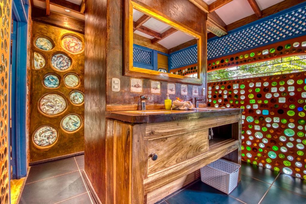 a bathroom with a wooden sink and a mirror at Tree House Beachfront Lodge in Puerto Viejo