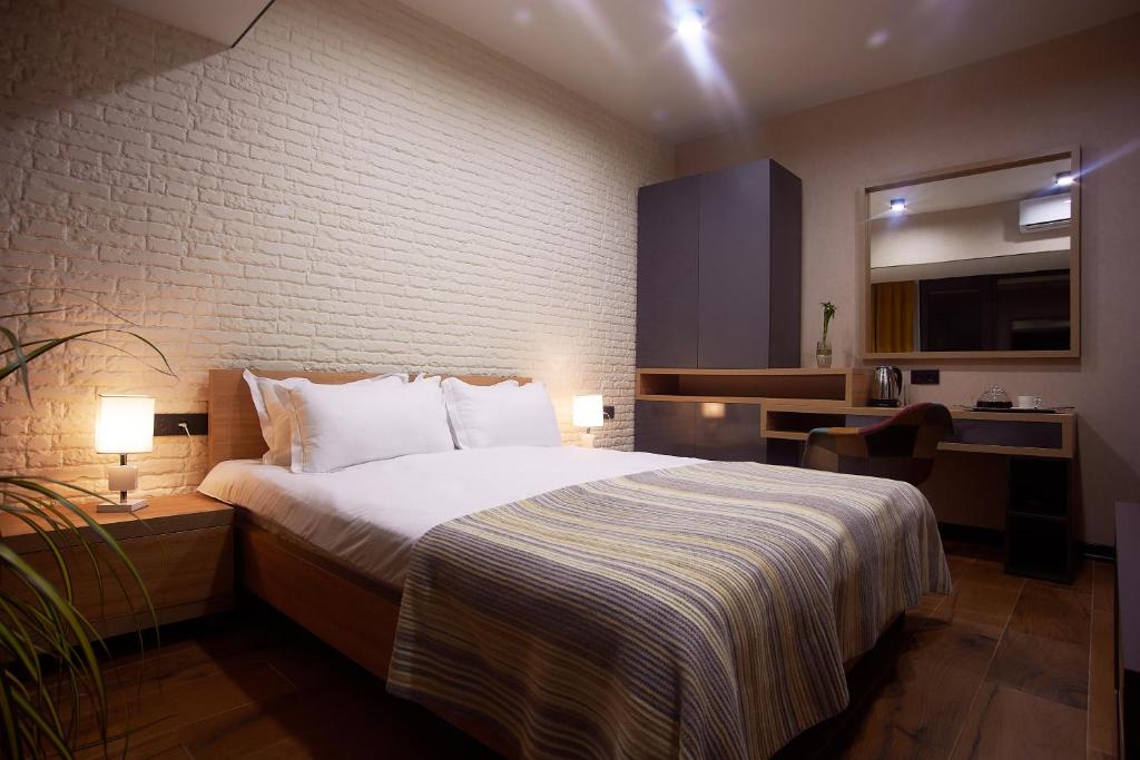 Postel nebo postele na pokoji v ubytování Green Boutique Hotel