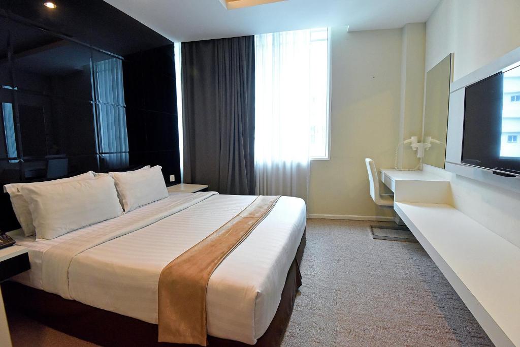 Postel nebo postele na pokoji v ubytování Jindagu Hotel Ipoh