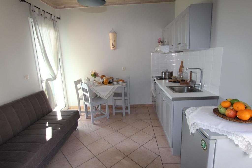 a kitchen with a sink and a counter with a table at Romanza Studios in Vasiliki