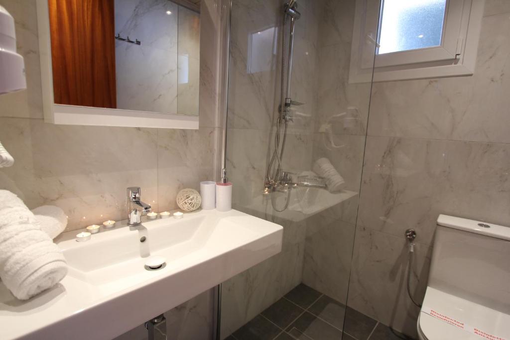 a bathroom with a sink and a shower at Romanza Studios in Vasiliki