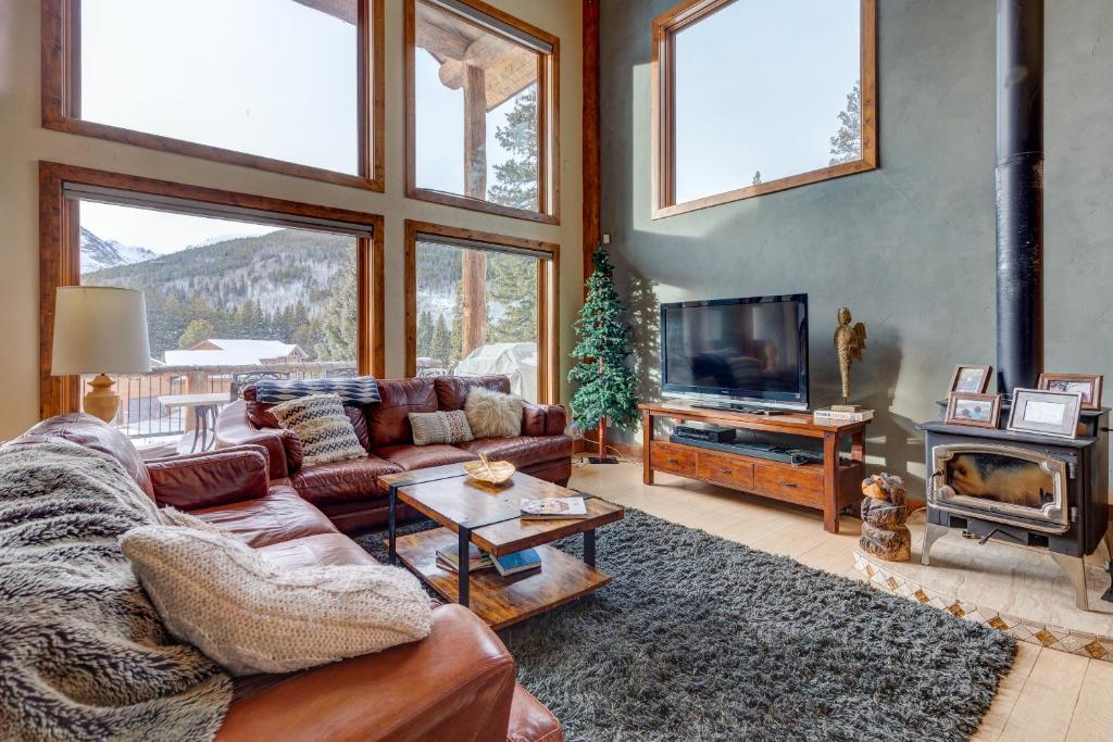 a living room with a couch and a television at 400 Whispering Pines in Blue River